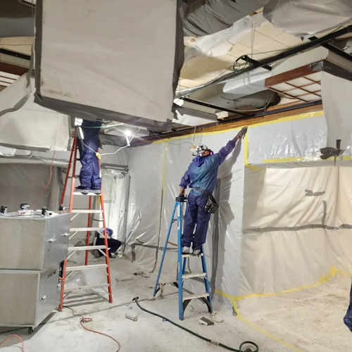 Certified abatement technicians at work